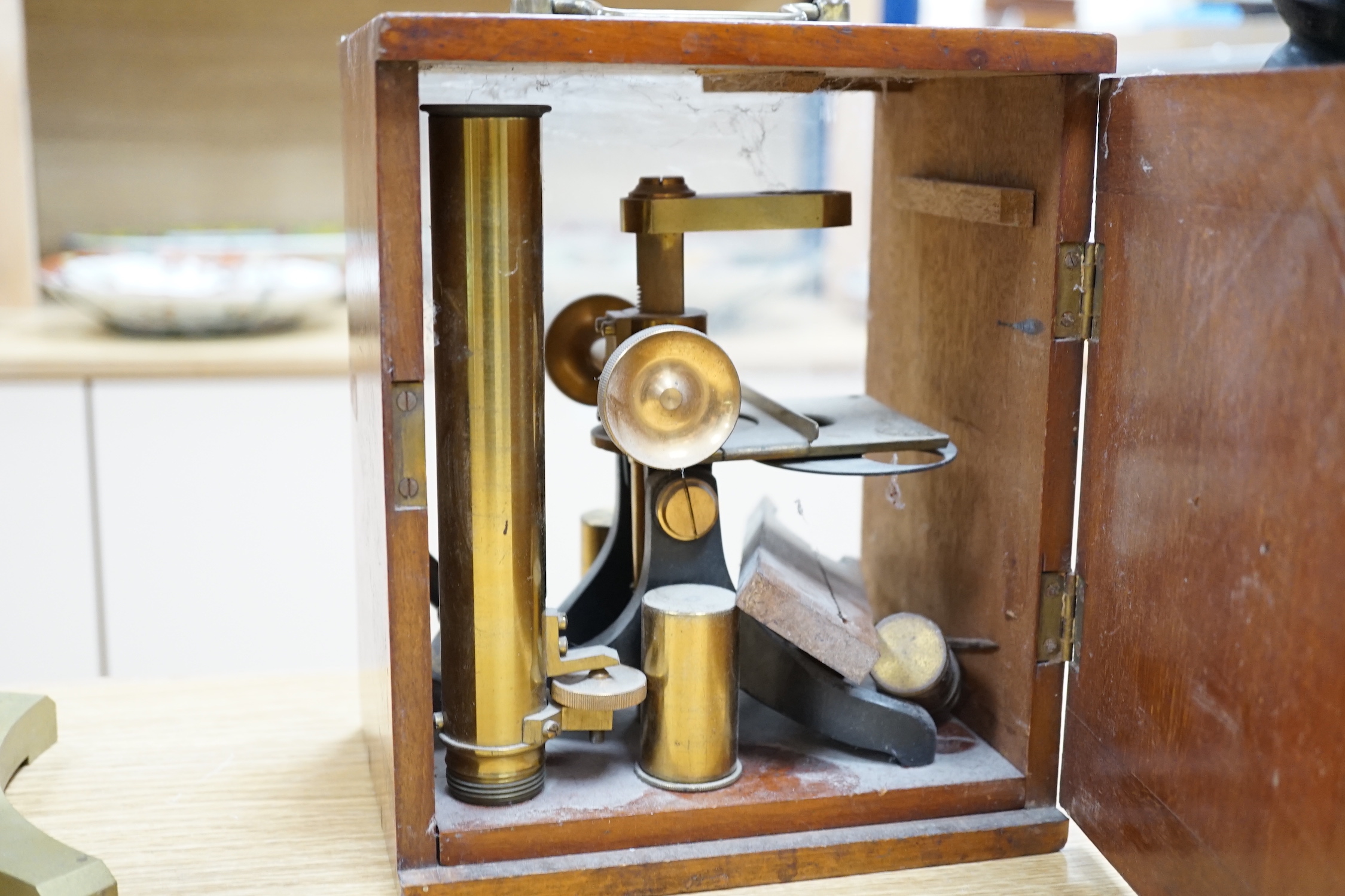 Three antique brass microscopes, one stamped R & J Beck London & Philadelphia, 37cm high